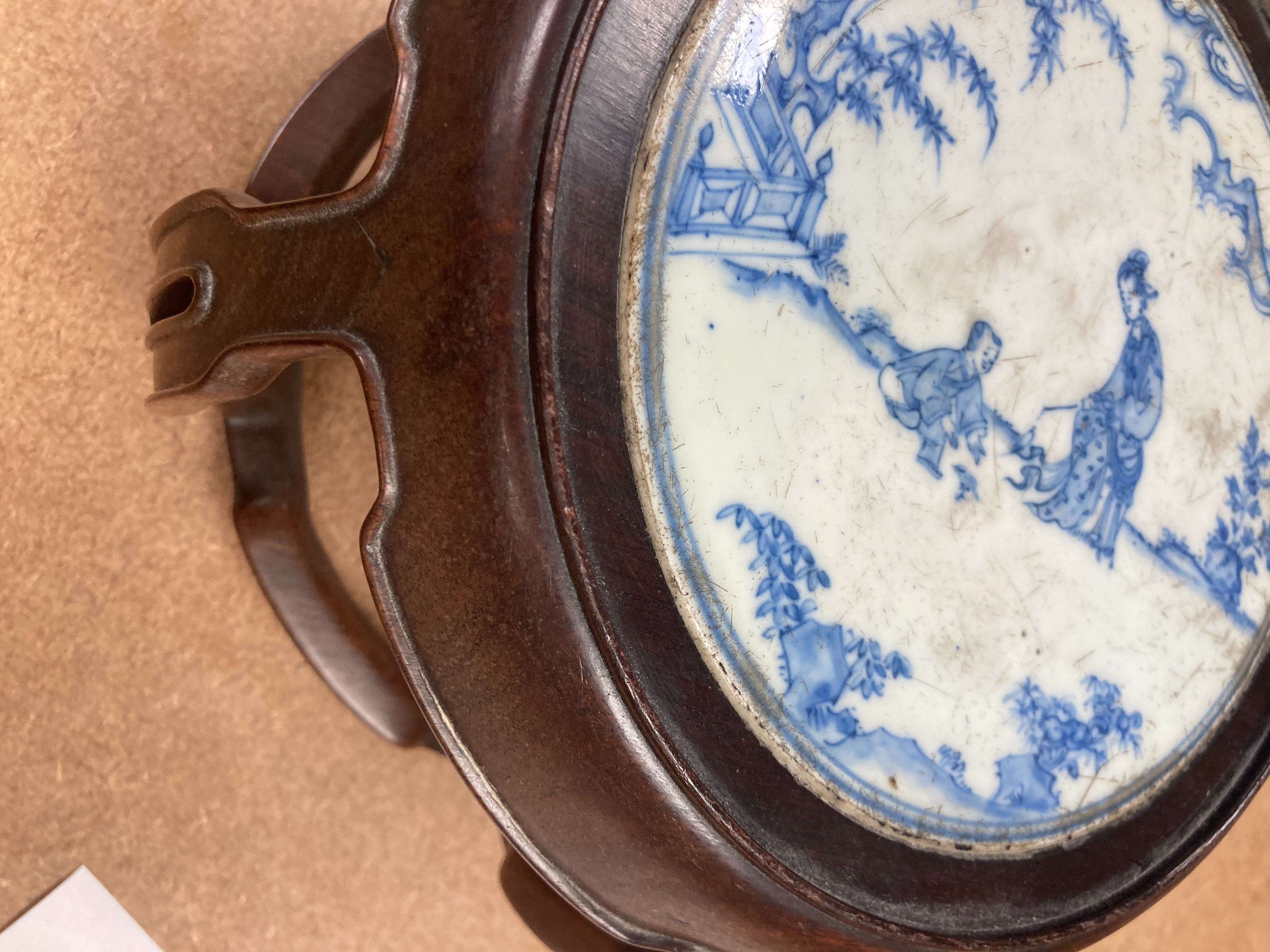 A 19th century Chinese blue and white circular tile inset hongmu stand, 22cm